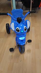 tricycle bébé thème Stitch coloré avec design inspiré du personnage Stitch
